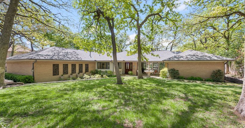 Stunning single-story home, tucked away on a lush, wooded .43-acre lot